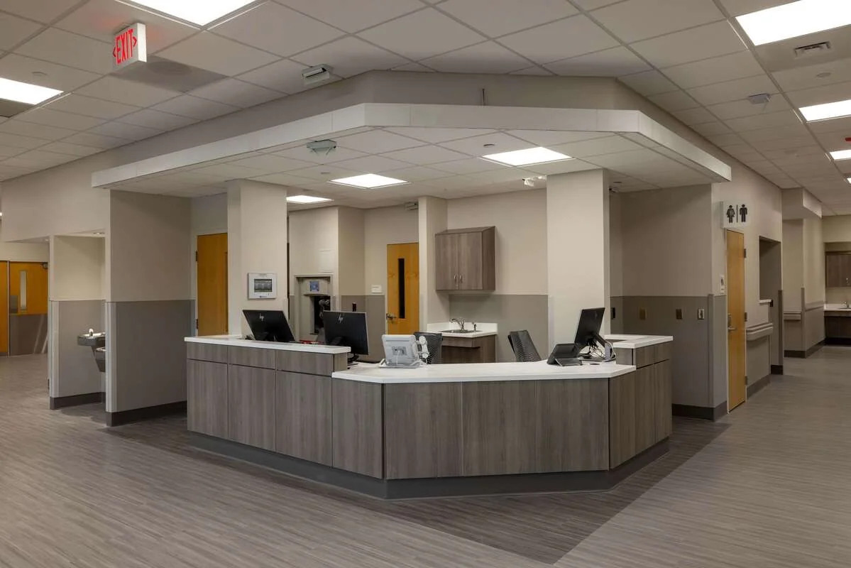 Curved commercial nurse station with gray cabinet fronts